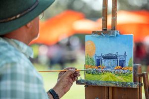 Featured Artist Member Hans Quinonez at his Easel